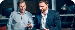 Two Office Workers With Tablet Office Late Night Young Businessmen Talking While Viewing Presentation Digital Touchscreen Tablet